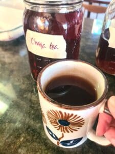 cup of warm chaga tea with cinnamon and maple